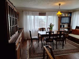 a living room with a dining room table and a couch at Kraavi Guest Hostel in Kuressaare