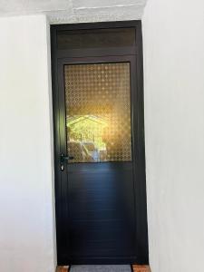a black door with a reflection of a car at Verolux bedroom service in Quatre Bornes