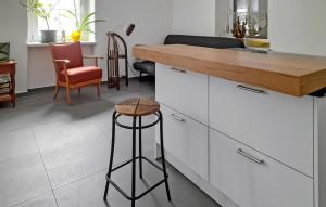 a kitchen with white cabinets and a wooden counter top at Ferienwohnung Schwarzenberg in Schwarzenberg