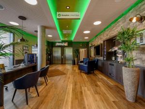 a lobby with green lights on the ceiling at ibis Styles Tuebingen in Tübingen