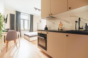 a kitchen with a sink and a stove top oven at Przytulny apartament przy dworcu in Radom