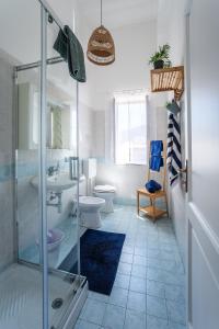 a bathroom with a shower and a toilet and a sink at Casa Norma in Lipari