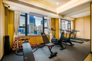 a gym with treadmills and exercise equipment in a building at Starlit sky Hotel - Shenzhen Luohu Baoneng Center Branch in Shenzhen