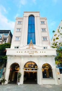 a white building with a sign on the front of it at A In Hotel Atistar in Ho Chi Minh City