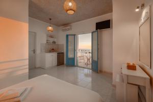 a large room with a kitchen and a living room at Nevma Suites in Firostefani