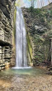 a waterfall on the side of a rock wall at Casa Con Vista Panoramica a Cerreto di Cagli - Animali Ammessi in Pianello +6 photos