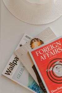 a pile of magazines sitting on top of a table at Nevma Suites in Firostefani