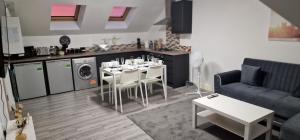 eine Küche und ein Wohnzimmer mit einem Tisch und Stühlen in der Unterkunft SAV Apartments Nottingham Road Loughborough - 2 Bed Apartment in Loughborough