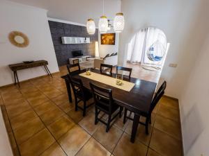 a dining room with a table and chairs at Casa Mela in La Oliva +10 photos