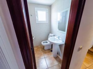 a bathroom with a toilet and a sink at Casa Mela in La Oliva