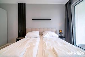 Posteľ alebo postele v izbe v ubytovaní Apartamenty BalticON Kasprowicza parking inclusive