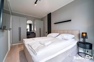 Posteľ alebo postele v izbe v ubytovaní Apartamenty BalticON Kasprowicza parking inclusive