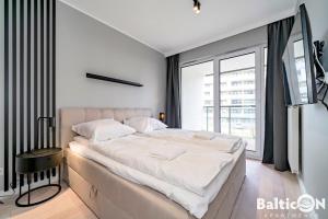 Posteľ alebo postele v izbe v ubytovaní Apartamenty BalticON Kasprowicza parking inclusive