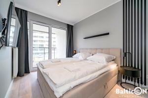 Posteľ alebo postele v izbe v ubytovaní Apartamenty BalticON Kasprowicza parking inclusive