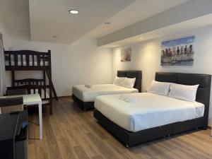 Postel nebo postele na pokoji v ubytování Neo Hatyai Hotel