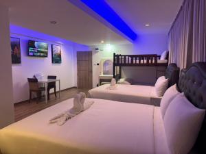 Postel nebo postele na pokoji v ubytování Neo Hatyai Hotel