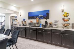 a kitchen with a large counter with a tv on the wall at Best Western Texas City I-45 in Texas City