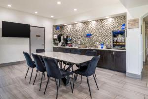 a dining room with a table and chairs and a counter at Best Western Texas City I-45 in Texas City