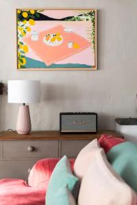 a bed with a lamp and a picture on the wall at Geranium Cottage in Port Isaac +25 photos
