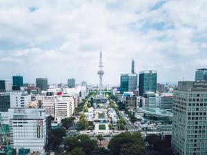 a city skyline with the eiffel tower in the distance at The Tower Hotel Nagoya in Nagoya