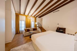 a bedroom with a bed and a living room at Palacio Ca Sa Galesa in Palma de Mallorca