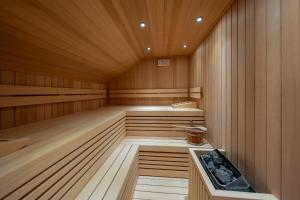a sauna with wood paneling and a tub in it at Palacio Ca Sa Galesa in Palma de Mallorca
