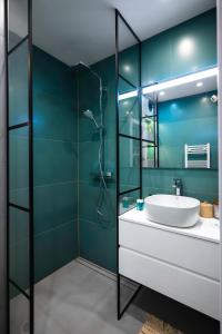 a bathroom with a sink and a glass shower at Exclusive One-Bedroom Retreat in Sofia