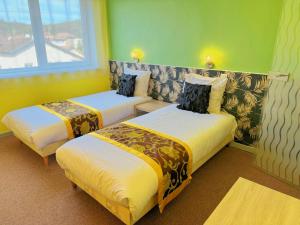 Postel nebo postele na pokoji v ubytování Hotel Le Ronchamp