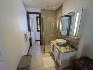 a bathroom with a sink and a mirror at Waterfront Maison by Simply-Seychelles in Eden Island