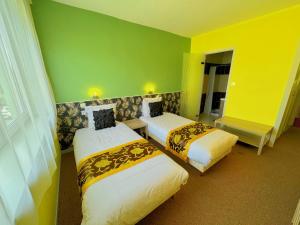 Postel nebo postele na pokoji v ubytování Hotel Le Ronchamp