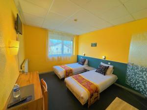 Postel nebo postele na pokoji v ubytování Hotel Le Ronchamp
