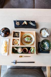 a table with plates of food and bowls of food at The Tower Hotel Nagoya in Nagoya