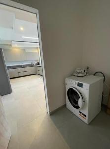 a washing machine in a room with a kitchen at Villa Messina in Capoliveri