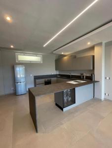 a large kitchen with a large island in a room at Villa Messina in Capoliveri