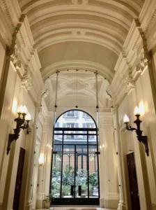 a hallway with a large window in a building at Les Jardins de l'Opéra - Elegant - Spacieux in Paris