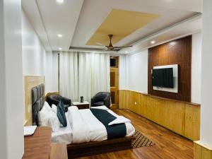 sypialnia z łóżkiem i telewizorem z płaskim ekranem w obiekcie Nirvana -A Balcony Rooms Hotel-A True View Of Mountains w mieście Manāli