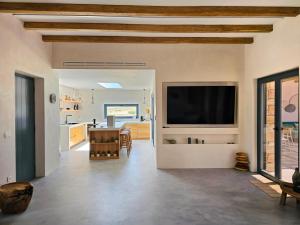 a living room with a flat screen tv on a wall at Lefki Sokolata in Koufonisia