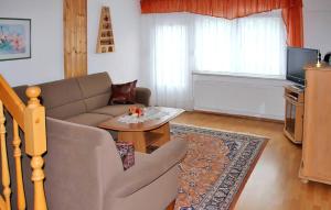 een woonkamer met een bank en een tafel bij 2 Bedroom Beautiful Home In Brenstein in Bärenstein