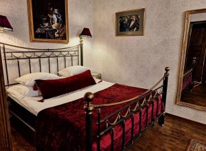 a bedroom with a bed with a red comforter at Vinoteegi Residents in Kuressaare