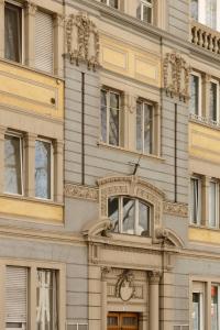 a building with an ornatevisor on the side of it at Electric Rooms & Suites in Trento