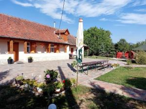 Tolcsva的住宿－Hegyalja Vendégház，院子中带桌子和旗帜的建筑