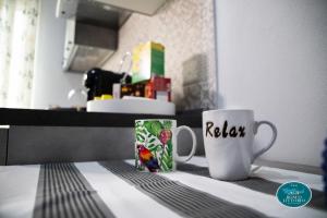 two coffee cups sitting on a counter in a kitchen at Le Dimore di Ulisse a Gela - Casa vacanze B&B - Bosco Littorio - Area archeologica in Gela