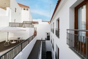 a view of the balcony of a building with a table at Porta da Arrábida Suites in Palmela