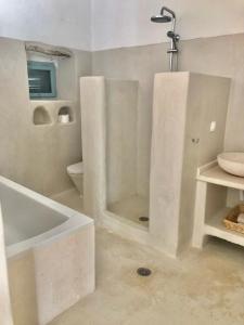 ein weißes Badezimmer mit Badewanne und Waschbecken in der Unterkunft Villa Xyloporta in Skinária