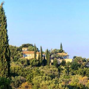 ein Haus auf einem Hügel mit Bäumen in der Unterkunft Villa Xyloporta in Skinária