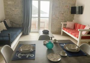 a living room with a table and a couch at Royal View in Mani in Kokkala