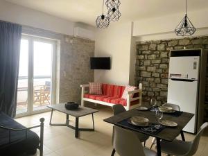 a kitchen and living room with a table and a refrigerator at Royal View in Mani in Kokkala