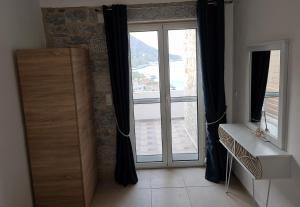 a room with a large glass door with a window at Royal View in Mani in Kokkala