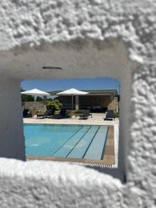 a view of a swimming pool with umbrellas at Masseria Giovanni in Martano