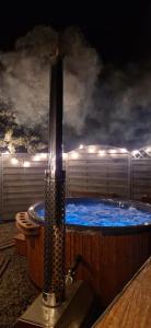 a large jacuzzi tub with blue water at night at Agroturystyka u Kozdryka in Leśna